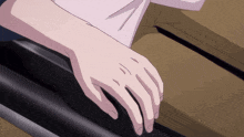 a close up of a person 's hand with a black object in the background