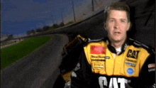 a man is wearing a yellow and black cat jacket