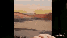a person is painting a landscape on a canvas with the words made in animatica visible