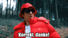 a man wearing a red jacket and a hat says korrekt danke