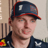 a man wearing a hat that says oracle racing