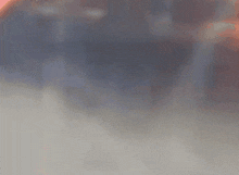 a blurred image of a person standing on a beach