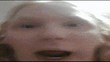 a close up of a woman 's face with a blurred background