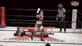 a woman in a wrestling ring with the word prominence written on the floor