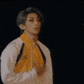 a man in a yellow and white jacket with the word mizuno on the front