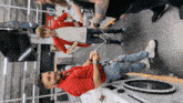a man in a red jacket is standing next to another man in a store