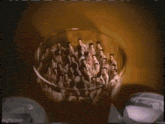 a group of men are standing in front of a cartoon character .