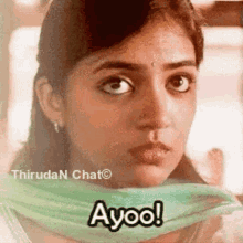 a woman is wearing a green scarf around her neck and says ayoo .