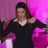 a woman in a black sweater is standing in front of a pink background that says ' steni no airl ' on it
