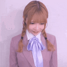 a girl wearing a purple jacket and a purple bow tie
