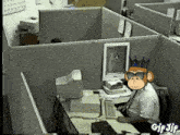 a monkey wearing sunglasses and a crown sits at a desk in an office cubicle