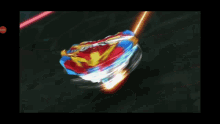a spinning top with a red , white , and blue top is spinning on a black surface .