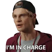 a man wearing a hat and a red hoodie says i 'm in charge