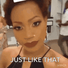 a woman is taking a selfie with the words `` just like that '' written below her .