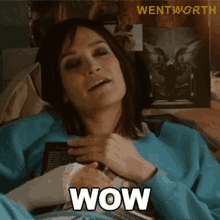 a woman with a cast on her arm is laying down and says wow
