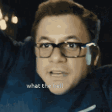 a man wearing glasses says what the hell