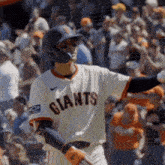 a baseball player for the giants swings his bat at the ball