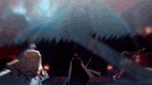 a blurry picture of a man holding a sword in a dark room