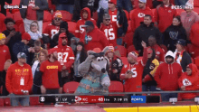a crowd of chiefs fans are watching a football game on cbs
