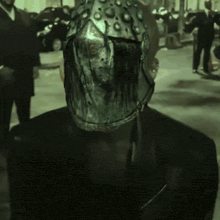 a man with a helmet on his head stands in a parking lot