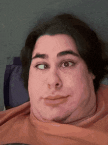 a close up of a person 's face with one eye closed and one eye open