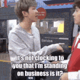 a man talking to another man in front of a delivery service sign