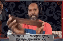 a man is wearing headphones and holding a piece of chocolate .