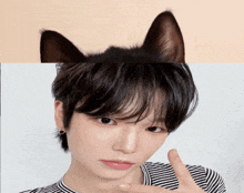 a close up of a person 's face with a cat 's ears behind it