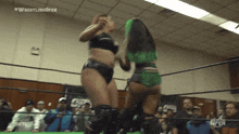 two women wrestling in a ring with the words #wrestlingopen on the bottom right