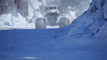a monster truck drives down a snowy road
