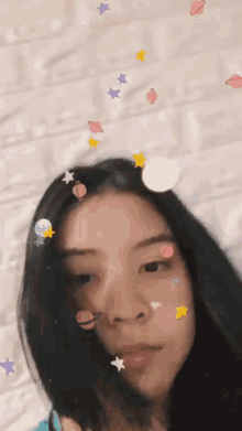 a girl with stickers on her face including planets stars and moons