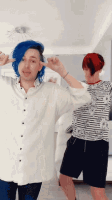 a man with blue hair is standing next to another man with red hair