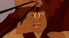 a cartoon character is wearing a gold ring on his finger .