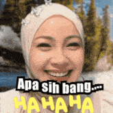 a woman wearing a hijab is smiling with the words apa sih bang .. hahaha above her