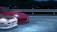 a red car with a license plate that says l3-137 is parked next to a white car