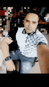 a man taking a selfie with a shirt that says lv on it