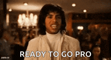 a man in a white suit is ready to go pro in a restaurant .