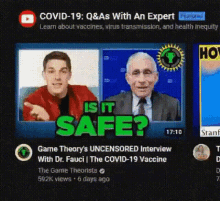 a man in a red jacket and a man in a suit are sitting next to each other on a video screen .