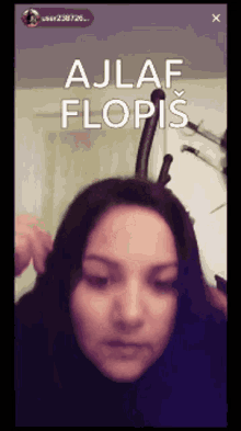 a woman 's face is shown with the words ajlaf flopis written above her