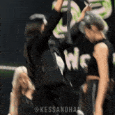 a group of women are dancing in front of a sign that says " we "