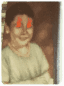 a blurry picture of a girl with red flames on her eyes