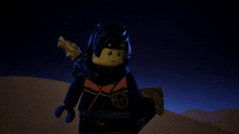 a lego ninjago character holding a sword in the desert