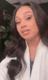 a woman is wearing a white robe and the word and is on the bottom