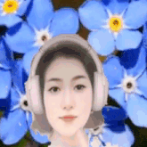 a woman wearing headphones is in front of a bunch of blue flowers .