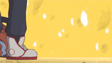 a person wearing a pair of white and red shoes with a red circle on the bottom