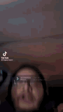 a woman wearing glasses is making a funny face in a tik tok video