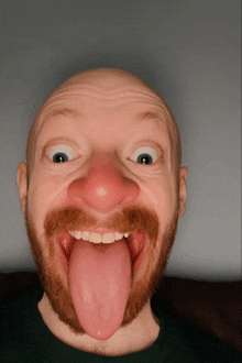 a bald man with a red nose and a beard sticking his tongue out
