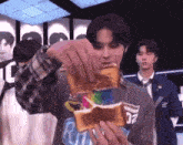 a man is holding a piece of toast that says ritz on it
