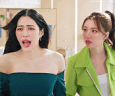 two women are standing next to each other in front of a dance sign