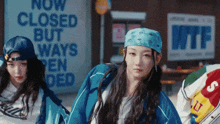 a group of girls are dancing in front of a sign that says now closed but ways opened
